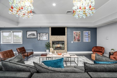a living room with couches and chairs and a fireplace